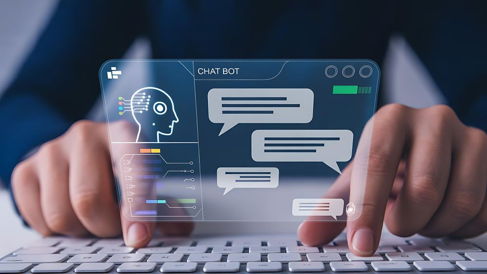 Hands typing on a white keyboard beneath a translucent chatbot window showing an AI head outline and message bubbles.
