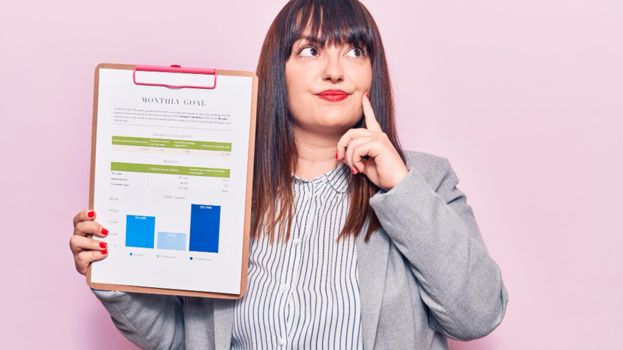 A woman holding a clipboard with a savings worksheet and chart.