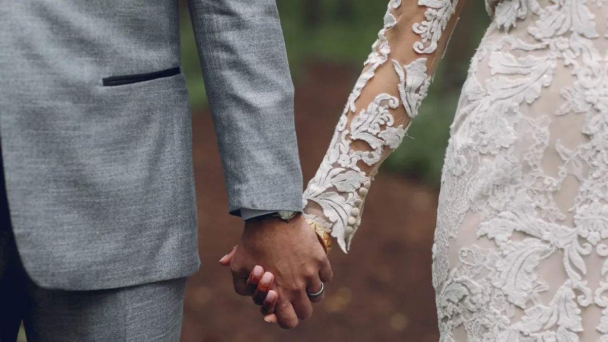 A picture of a married couple holding hands.